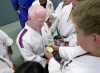 Scott Moore sharing gold medal with judo kids, Paralympians training at Cahill's Judo Academy